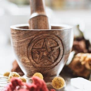 wooden mortar and pestle carved with pentacle